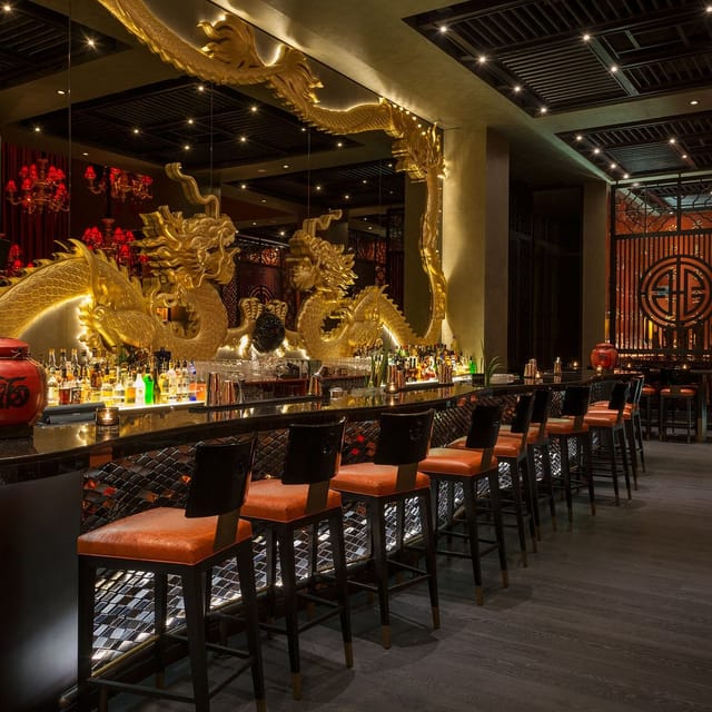 Main Dining Area at Buddha-Bar Dubai with dragon sculptures, elegant for cocktail events.