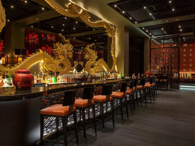 Lounge at Buddha-Bar Dubai with ornate dragon decor, ideal for upscale events.
