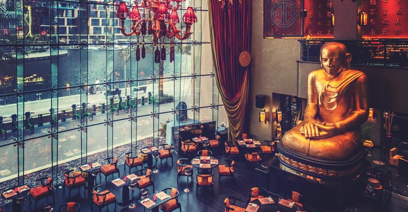 Buddha-Bar Dubai lounge with golden Buddha statue, elegant for upscale events.