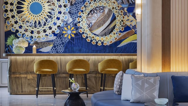 VIP Astor Boardroom, stylish lobby with intricate wall patterns for meetings and events.