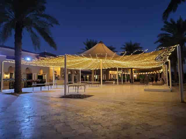 Outdoor event space at Dubai Polo Club with string lights, ideal for gatherings.