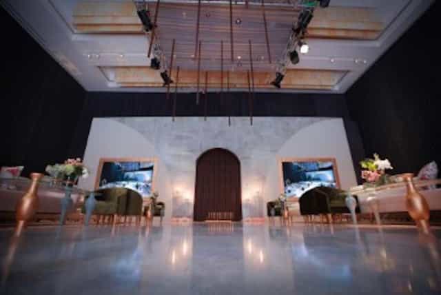 Elegant wedding venue at Hilton Riyadh with stylish seating and dramatic lighting.