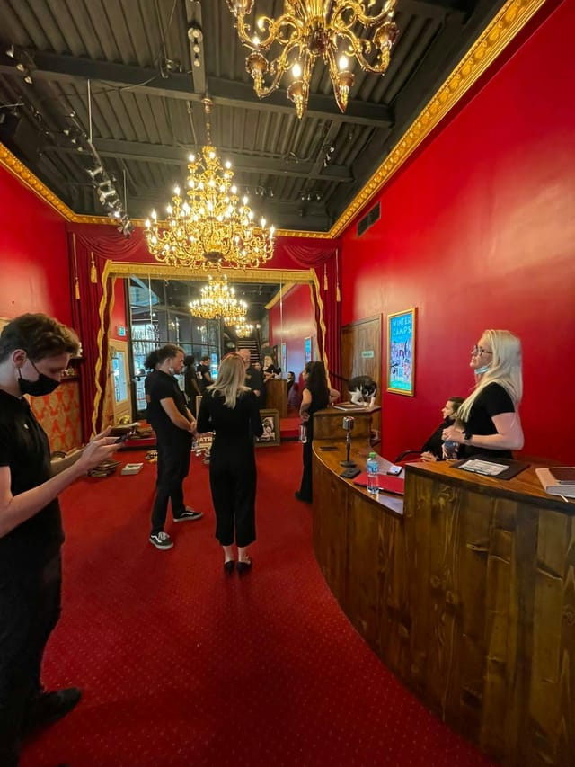Improv Studio at Courtyard Playhouse, vibrant red decor, ideal for networking events.