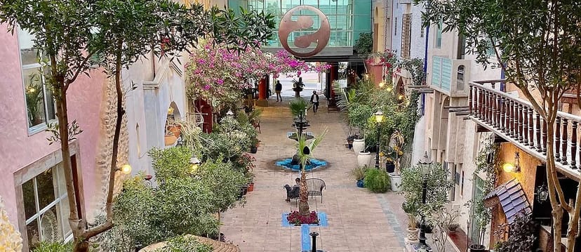 Outdoor event venue with greenery and fountains at Improv Studio, Courtyard Playhouse.