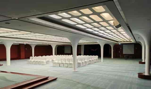 Queens Room in Queen Elizabeth 2: elegant event hall for conferences with white seating.