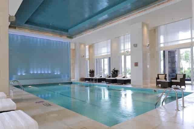 Pool Terrace at Ritz-Carlton Dubai: serene hotel pool for networking and relaxation.