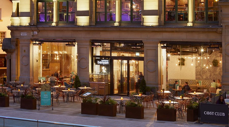 Vibrant restaurant with outdoor seating, perfect for meetings and events in Banyan Corn Exchange. - Banner