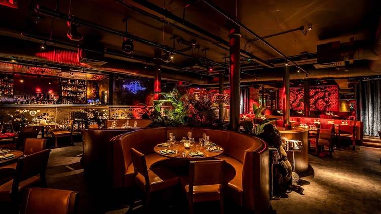 Stylish MNKY Restaurant venue with warm lighting, perfect for private events and upscale dining. - Banner