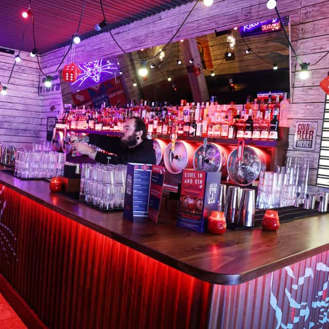 Vibrant bar setup with illuminated shelves, ideal for social gatherings and events.