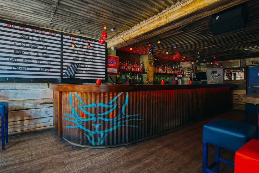 Vibrant Mean Eyed Cat Bar with cat mural, ideal for casual gatherings and events.