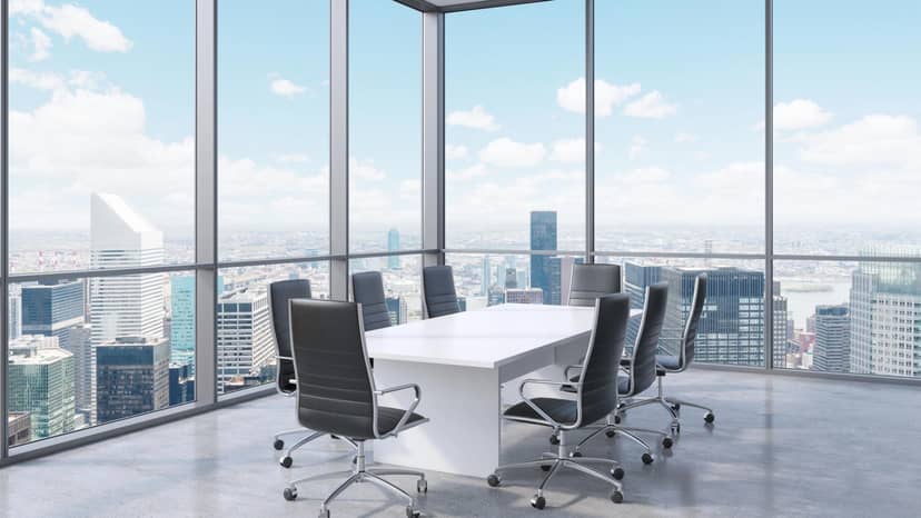 Modern conference room with skyline view, ideal for meetings and brainstorming.