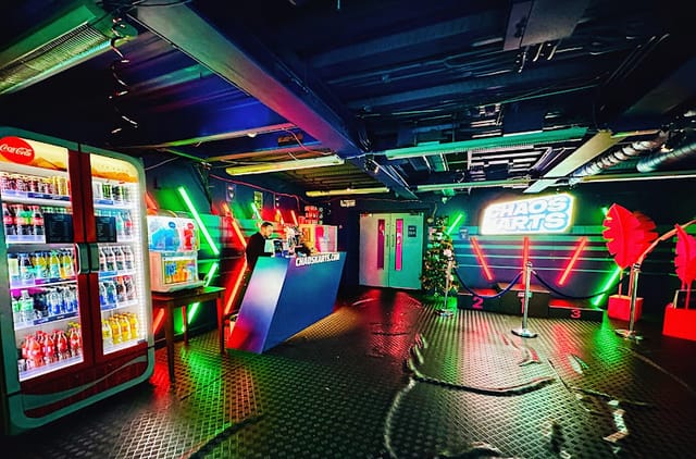Go-kart track at Chaos Karts with neon lighting for parties and events.