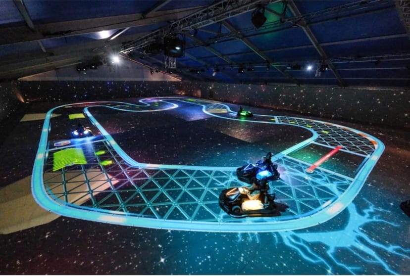 Dynamic go-kart track with illuminated circuit for corporate events and team-building.