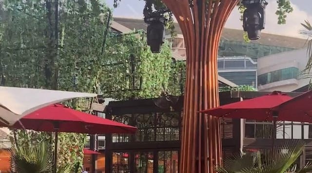 "Outdoor event space in Soho Garden with red umbrellas, ideal for networking and gatherings."