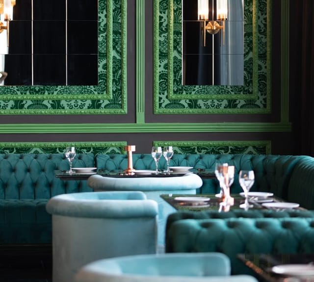Elegant event space with plush turquoise seating in Soho Garden, perfect for corporate dinners.