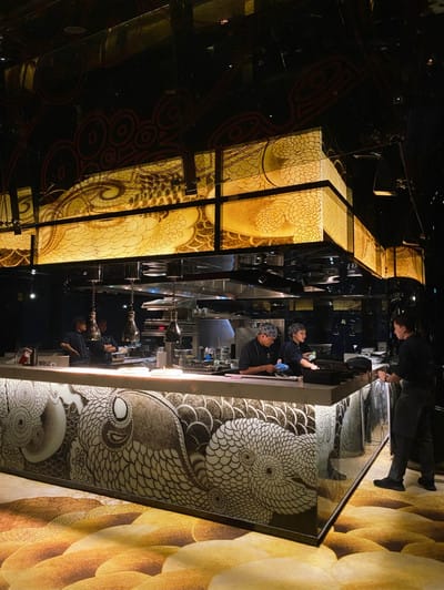 Upscale kitchen in CUSCO ROOM for high-end events, featuring skilled chefs and artistic lighting.
