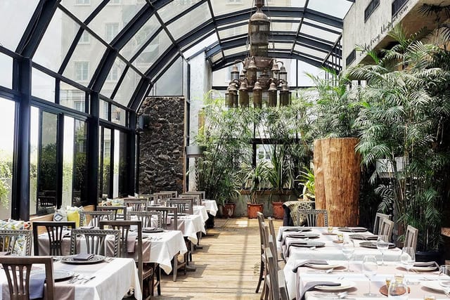 Dining hall at Omah Sendok with glass atrium, ideal for events and private dinners.