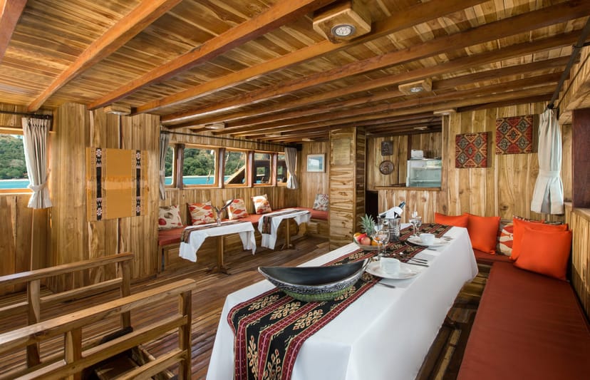 Private Cruises Komodo meeting space on a wooden vessel, ideal for retreats and gatherings.