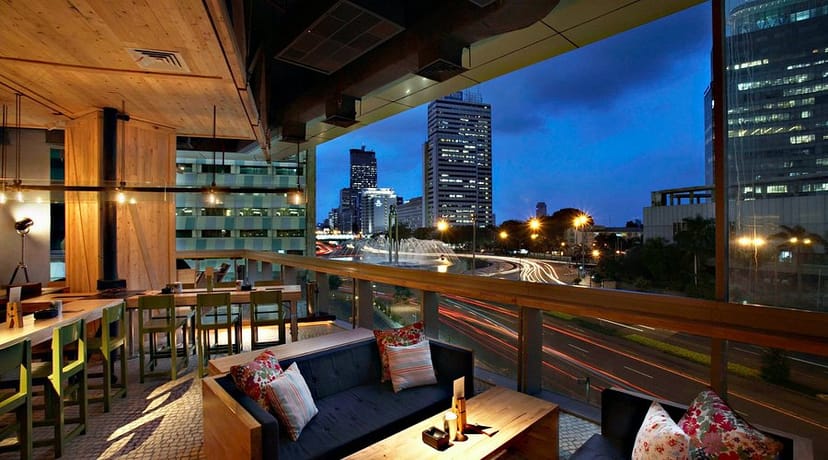 Modern rooftop wine store with city skyline, ideal for corporate events and social gatherings.
