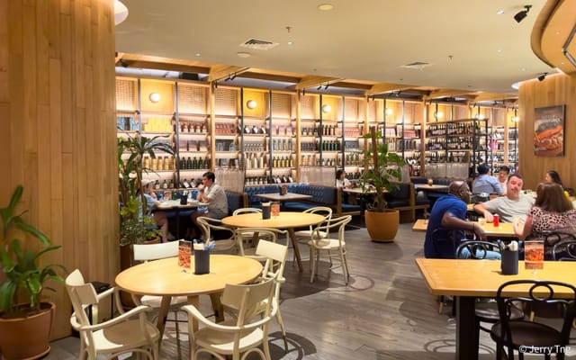Modern wine store interior with wooden accents, ideal for dining and networking events.