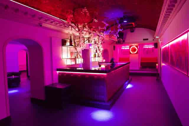 Stylish TOY ROOM venue with pink lighting, perfect for upscale cocktail receptions.