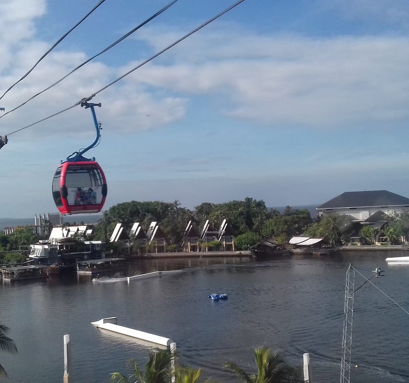 Gondola Ancol amusement park ride above scenic water, perfect for corporate retreats.