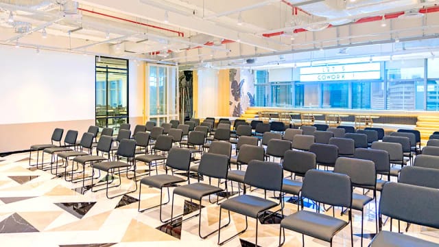Spacious modern event venue with flexible seating for workshops and presentations.