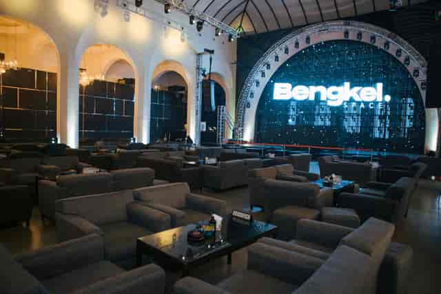 Sophisticated Bengkel Space venue with sleek grey furniture for corporate events.