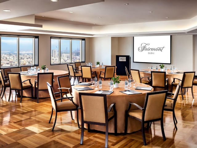 Meeting room at Fairmont Dubai Opera with circular seating and city views for corporate events.