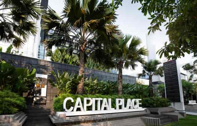 Modern retail podium at Capital Place with lush greenery, ideal for events and conferences.