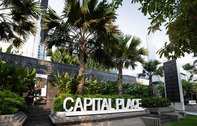 Modern retail podium at Capital Place with lush greenery, ideal for events and conferences.