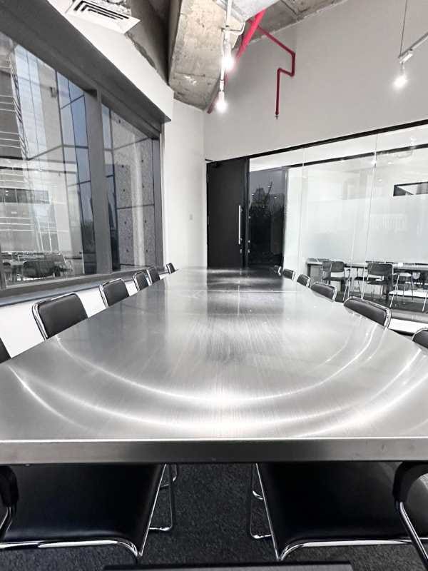 Modern conference room in Infiniti Office with a sleek metal table for meetings.