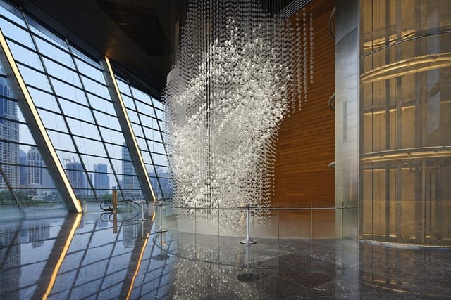 Grand Circle Foyer, Dubai Opera, modern atrium with art installation, event venue.