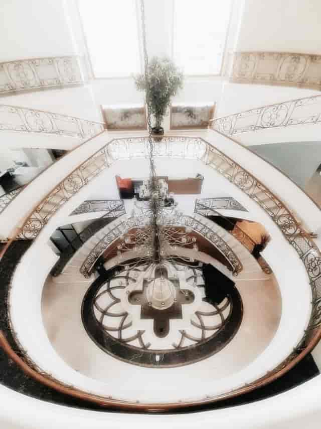 Elegant ballroom with spiral staircase and chandelier for upscale events in Toeti Roosseno Plaza.