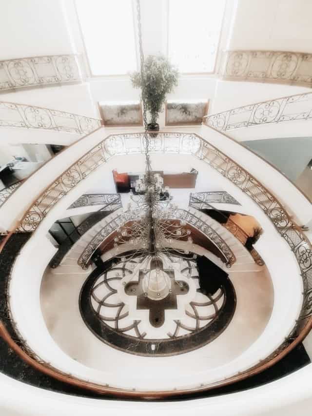 Elegant ballroom with spiral staircase and chandelier for upscale events in Toeti Roosseno Plaza.