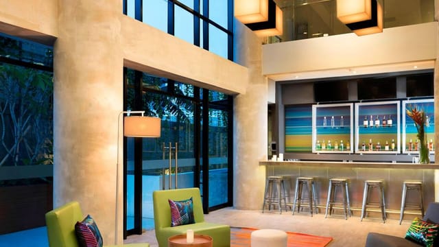 Modern lounge area for networking events at Aloft Jakarta Wahid Hasyim.