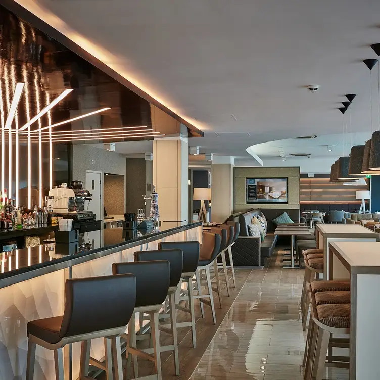 Modern bar area in AC Hotel Manchester, ideal for networking events and casual meetings. - Banner