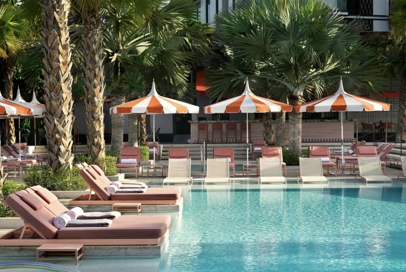 Upscale Banyan Tree Dubai poolside lounge with vibrant umbrellas, ideal for events