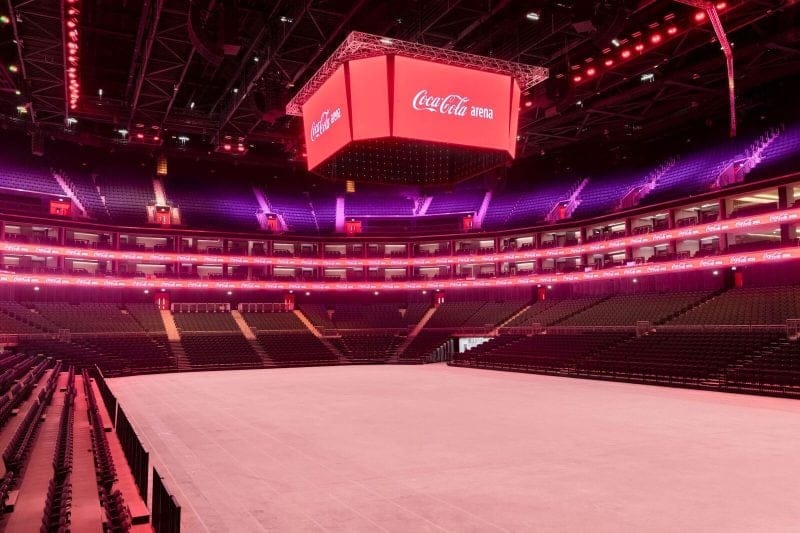 Coca-Cola Arena's Main Arena set for events, featuring vibrant branding and flexible seating.