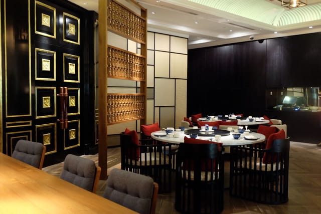 Elegant round table dining space in JIA for intimate gatherings and corporate dinners.