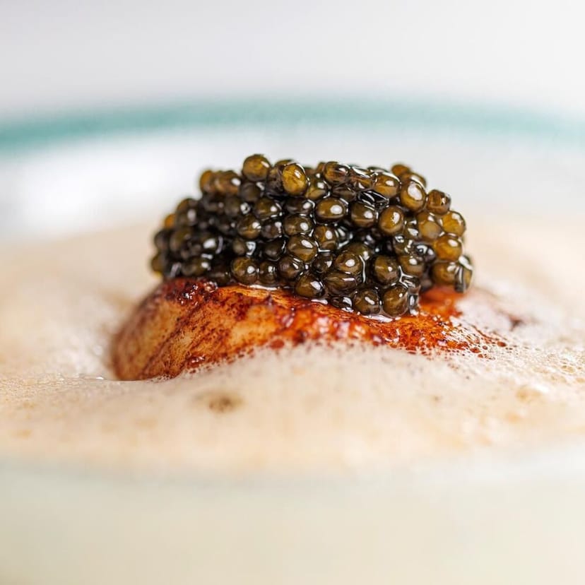 Elegant fish dish with caviar at Petit Amour restaurant for catering events.