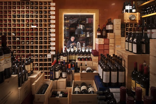 Well-stocked wine cellar at Alimentari Gallo Nero, perfect for tastings and exclusive events.