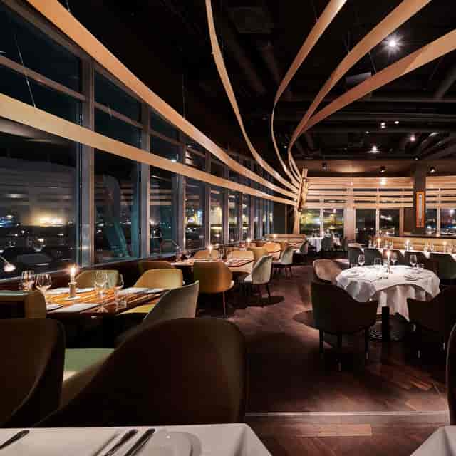 Sophisticated restaurant venue with panoramic views, perfect for corporate gatherings and events.