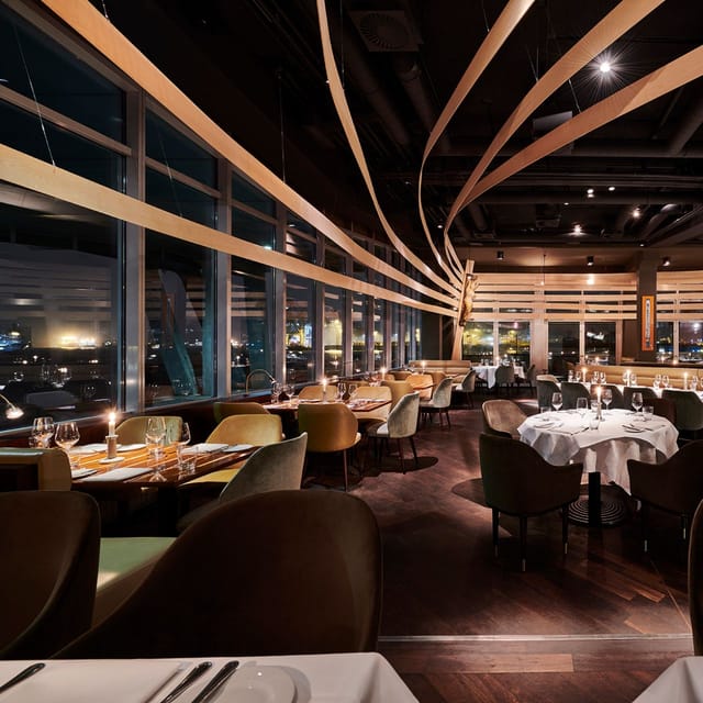 Sophisticated restaurant venue with panoramic views, perfect for corporate gatherings and events.