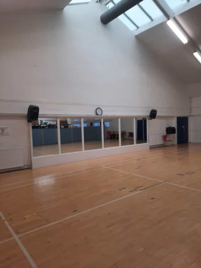 Versatile event space with mirrors in Colombo Sports & Community Centre for workshops and fitness.