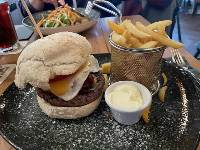 Gourmet burger with fries at Bistro Dein ALEX, perfect for events and networking.