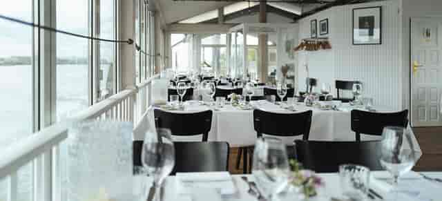 Elegant dining area with waterfront view, perfect for weddings and corporate events.