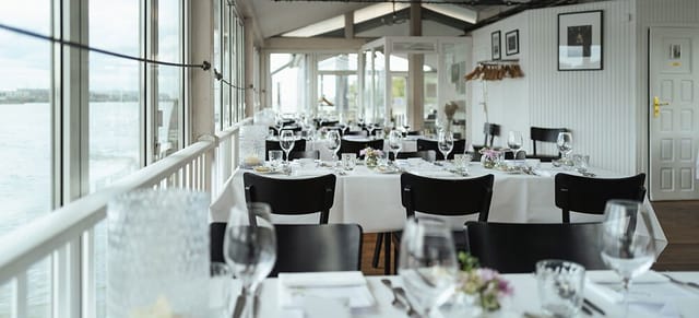 Elegant dining area with waterfront view, perfect for weddings and corporate events.