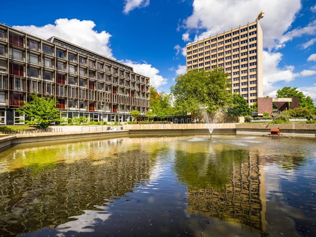 Philosophenturm at Universität Hamburg: modern venue with serene pond for events.