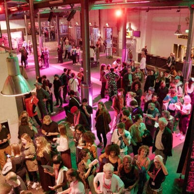 Kampnagel Theater event with diverse crowd and vibrant ambiance for networking opportunities